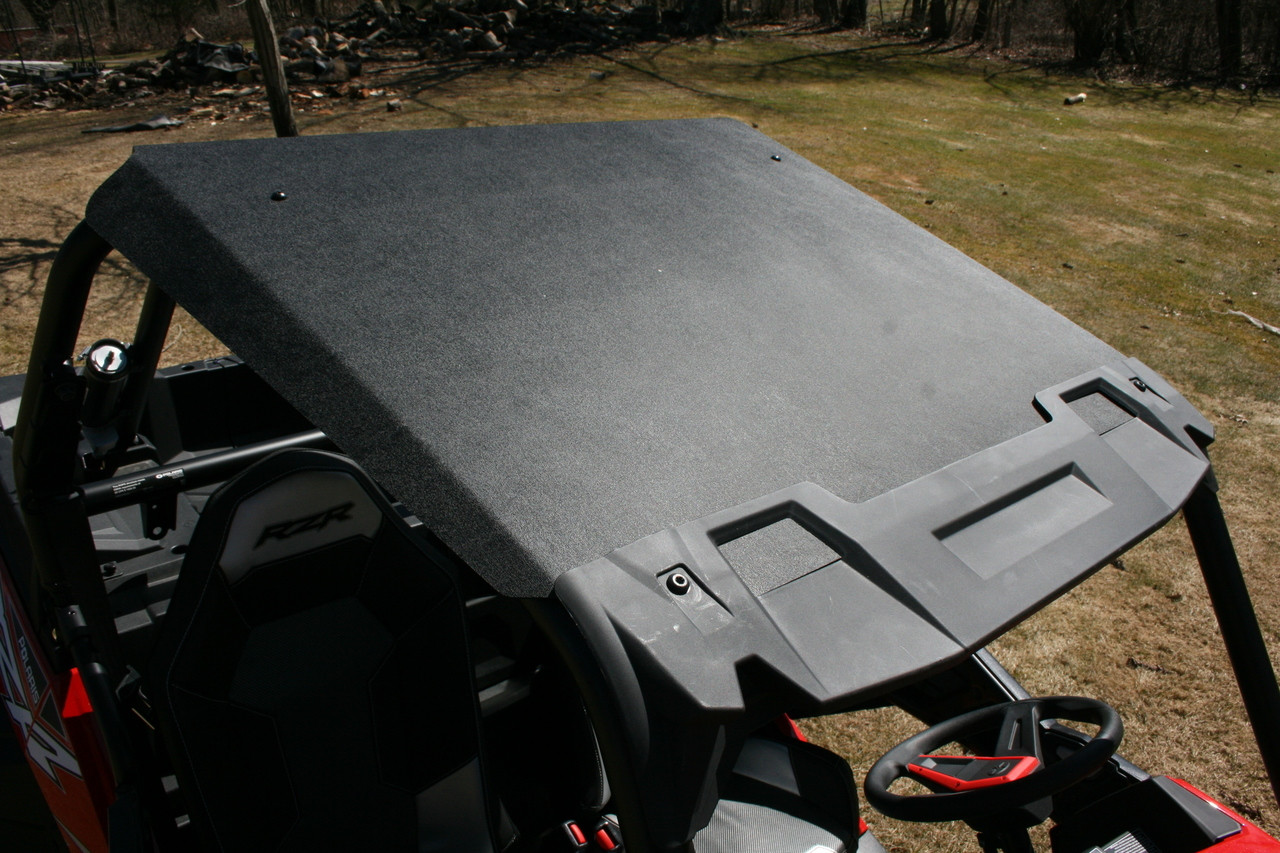 Spike Powersports black hard roof installed on a red Polaris RZR, viewed from above the cab
