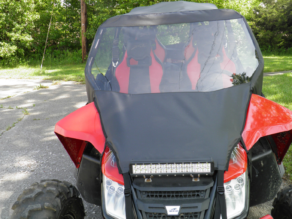 Front view of a red Arctic Cat Wildcat 4 with the 3 Star vinyl windshield, soft top and LED light bar