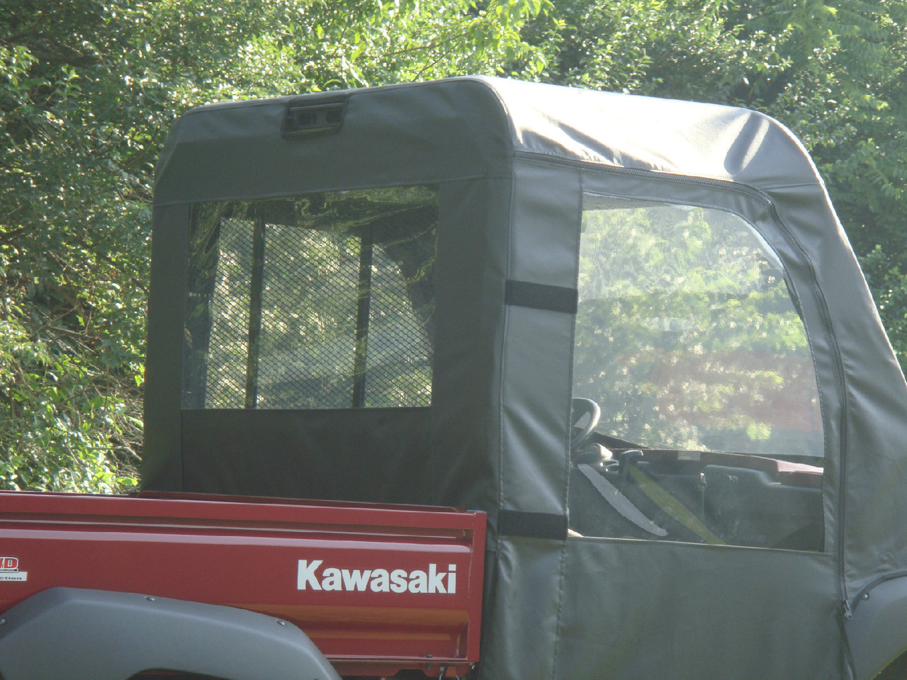 Rear view of the 3 Star cab enclosure rear window panel on the red Kawasaki Mule above the cargo bed
