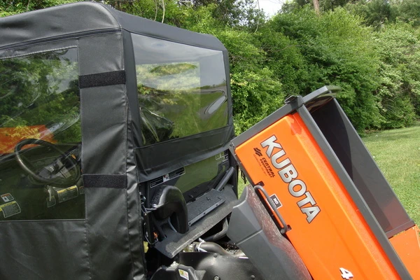 Close-up of the rear window panel of the 3 Star enclosure with the Kubota RTV dump bed tilted up