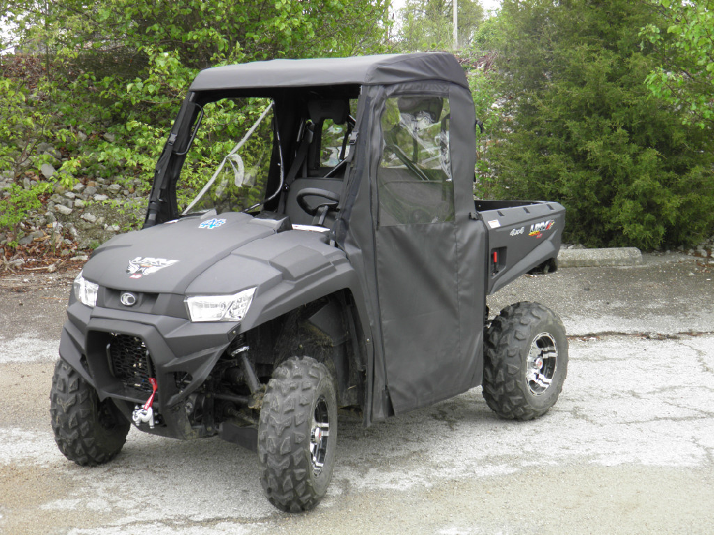 Front three-quarter view of a black Kymco 450i wearing the 3 Star full cab enclosure with soft doors and roof