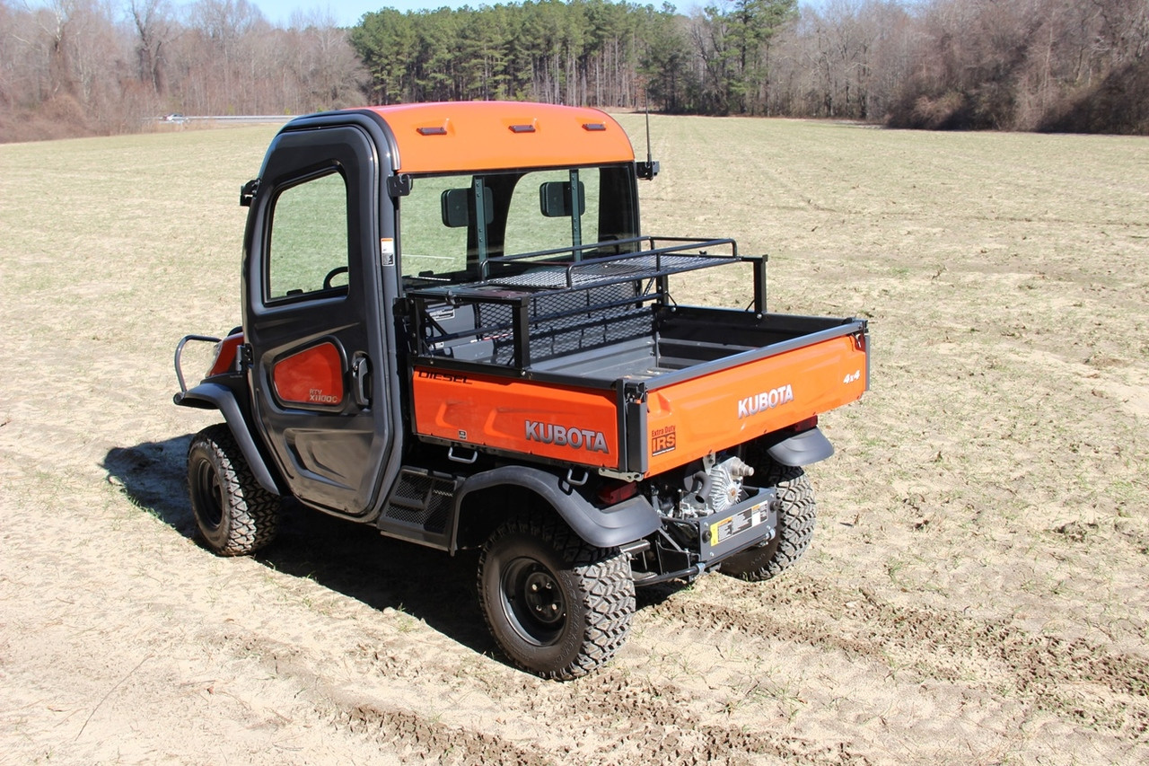 Seizmik universal rear dump bed rack mounted on an orange utility side-by-side, rear three-quarter view