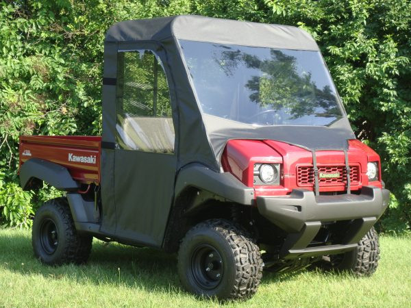 3 Star full cab enclosure with vinyl windshield on a red Kawasaki Mule 4000/4010, front three-quarter view on grass