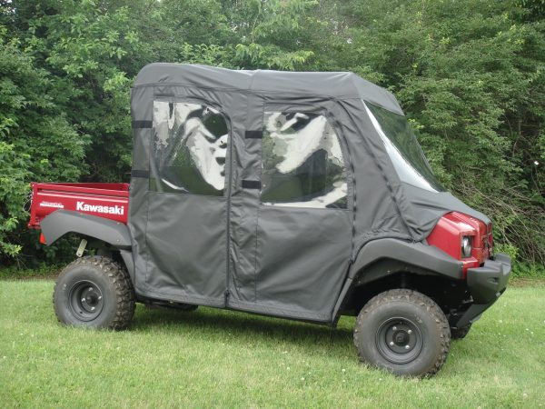 Driver side front three-quarter view of the red Kawasaki Mule 4010 Trans with the 3 Star soft cab