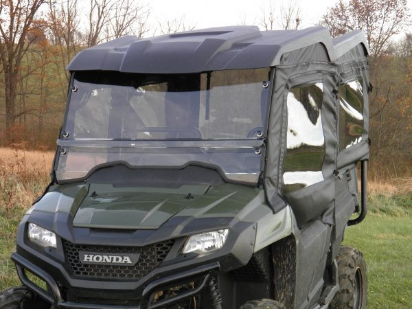 3 Star full cab enclosure vinyl windshield and soft doors shown on a green side-by-side, front close-up