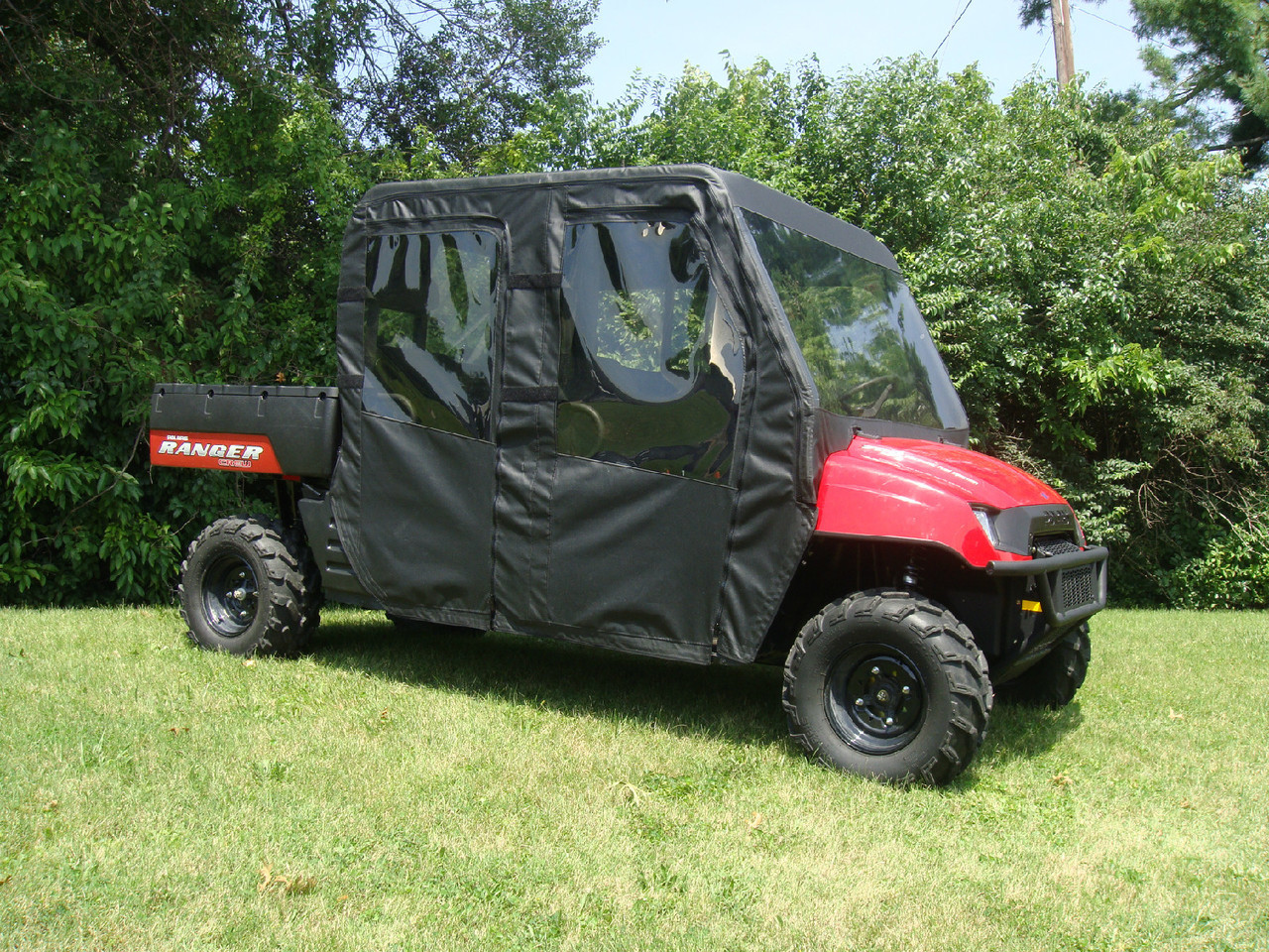 Side view of the Polaris Ranger 700 Crew with the 3 Star soft doors and windows zipped closed
