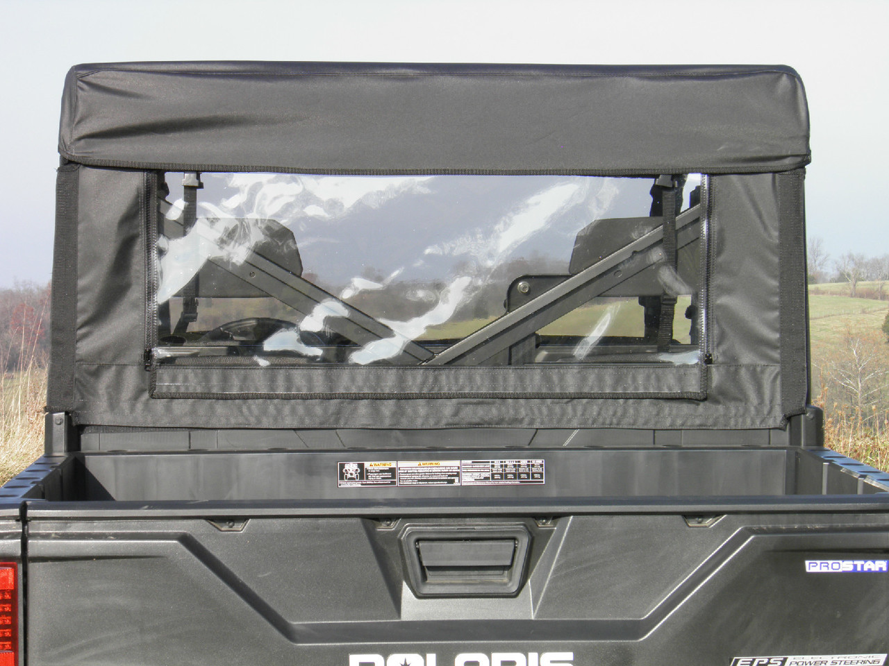 Rear view of the 3 Star clear vinyl rear window and soft top on the Polaris Ranger 570-4, seen over the bed