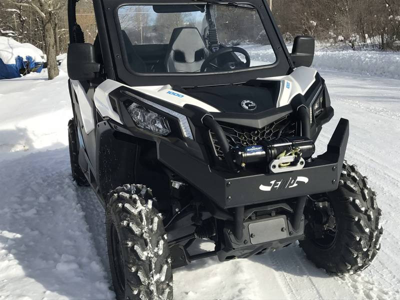 Extreme Metal Products front brush guard and winch mount on the white Can-Am Maverick Trail parked in snow, front angle