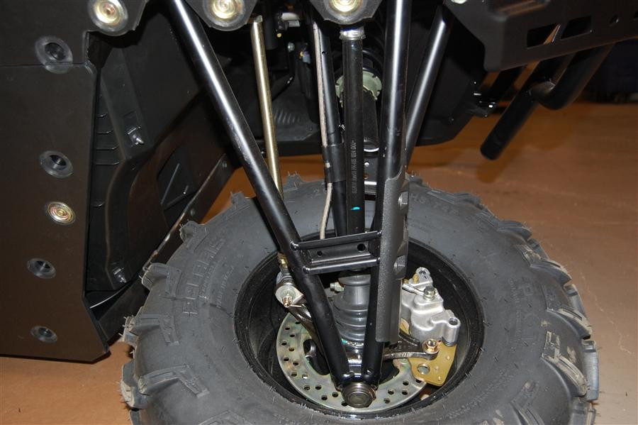 Close-up of a black Trail Armor CV boot guard mounted on the front lower A-arm of a Polaris Ranger XP1000