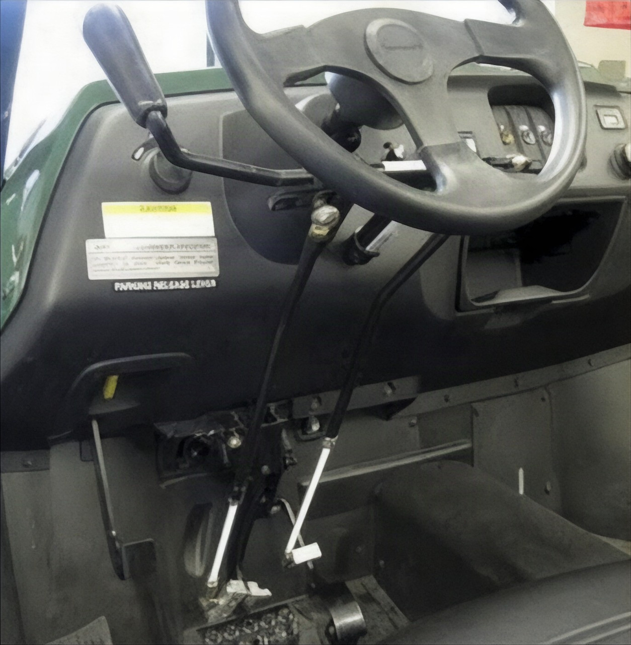 Sure Grip hand controls installed under the dash of an Arctic Cat Prowler, push-pull lever beside the steering wheel
