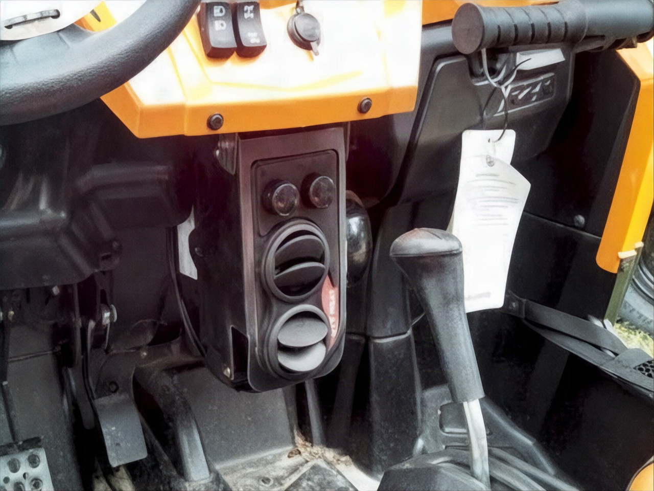 Ice Crusher heater box with two round vents and switches mounted under the dash of a Polaris RZR beside the shifter