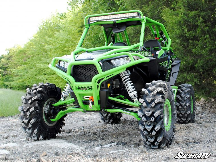 SuperATV 30-inch curved LED light bar mounted on the roof of a lime green side-by-side, front three-quarter view