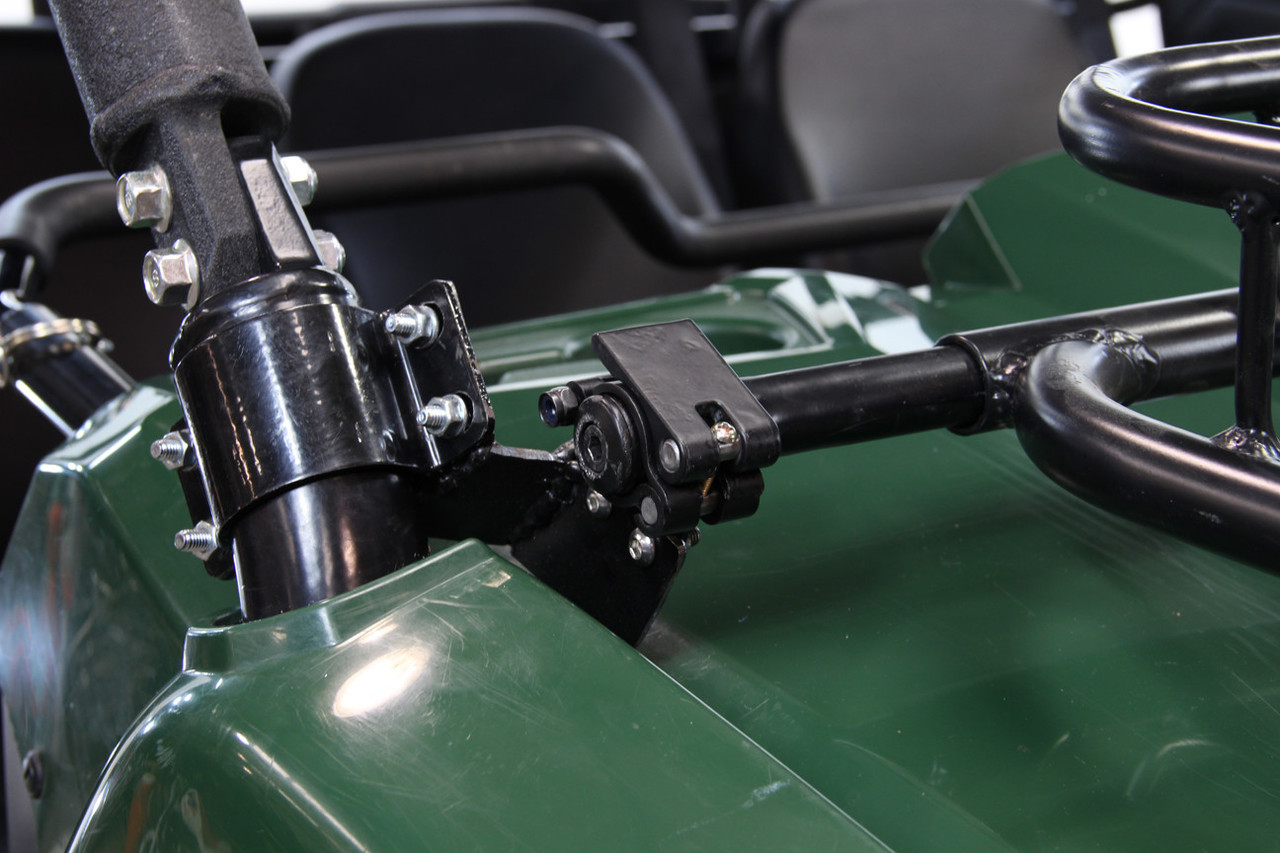 Close-up of the Seizmik hood rack clamp bracket bolted to the cage pillar of a green Yamaha Viking