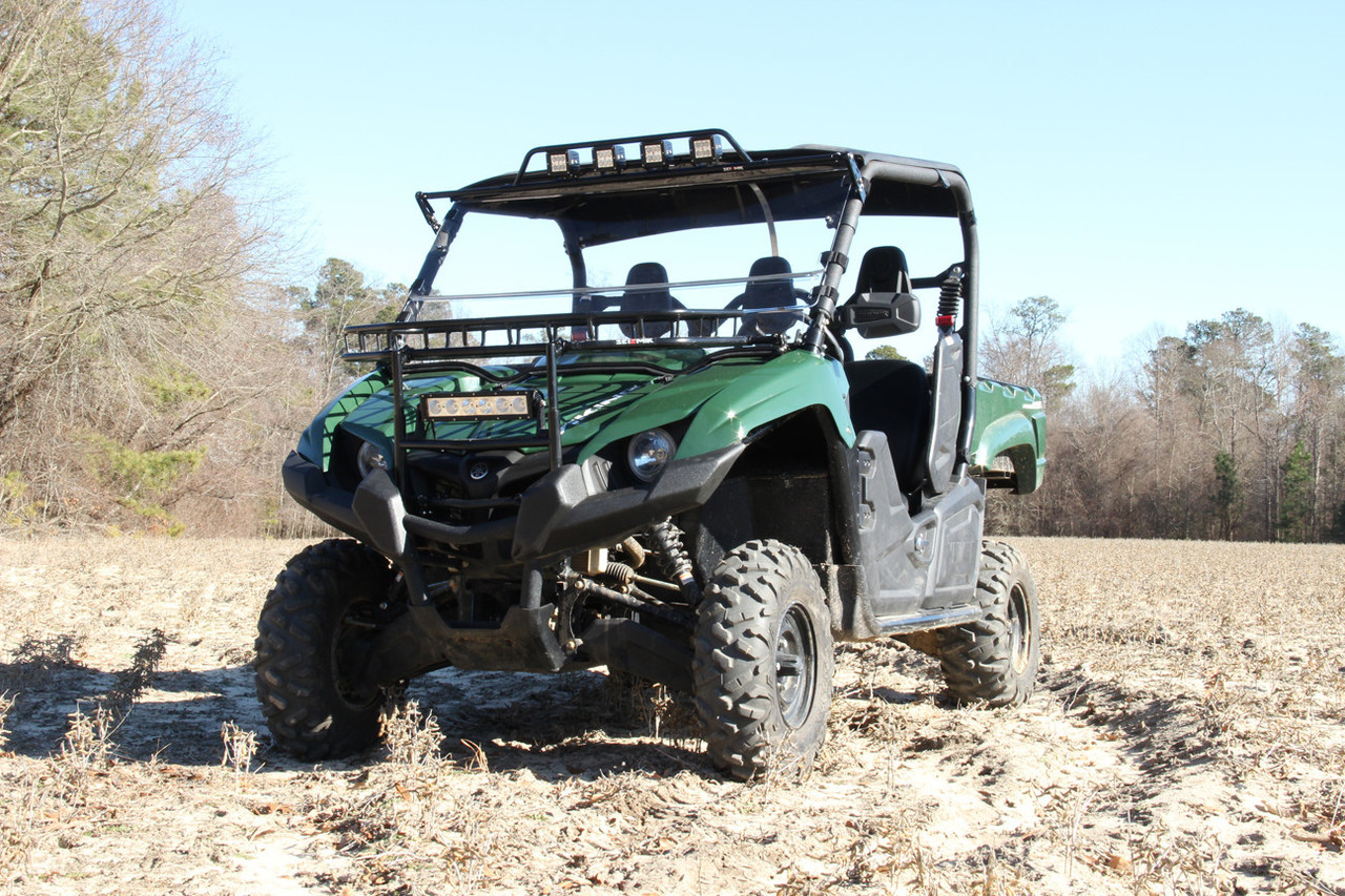 Front three-quarter view of a green Yamaha Viking VI in a field with the Seizmik hood rack installed