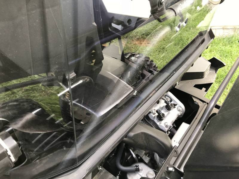 Close-up of the Extreme Metal Products cab back lower edge behind the Yamaha Wolverine X2 seat and bed rail