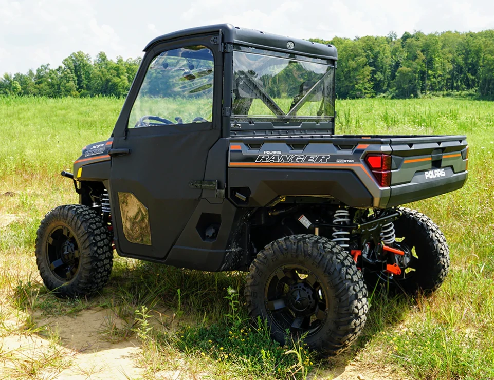 Rear three-quarter view of a Polaris Ranger XP 1000 with Spike doors and rear window installed, in a field