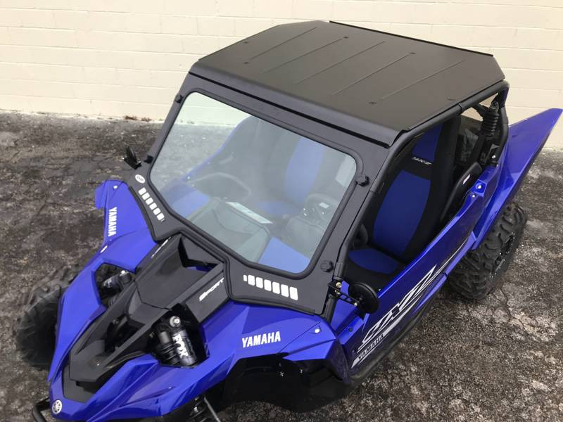 Elevated front three-quarter view of the blue Yamaha YXZ with the Extreme Metal Products aluminum top on pavement