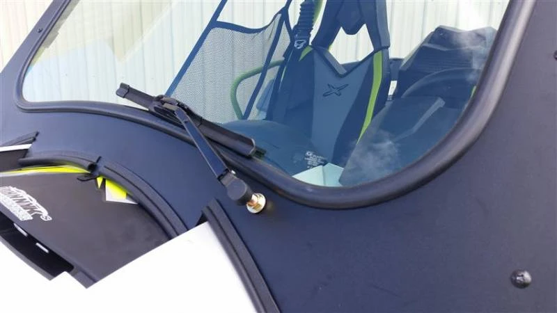 Close-up of the wiper arm pivot and frame edge of the Extreme Metal Products Can-Am Maverick glass windshield