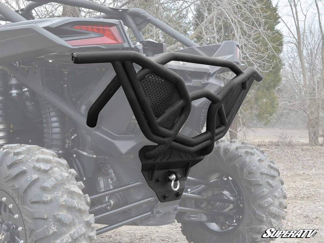 Angled close-up of the SuperATV Maverick X3 rear bumper showing the mesh panels and shackle mount plate