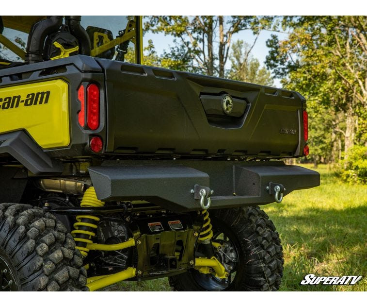 Driver side rear three-quarter view of the SuperATV rear bumper end on a Can-Am Defender, exhaust visible