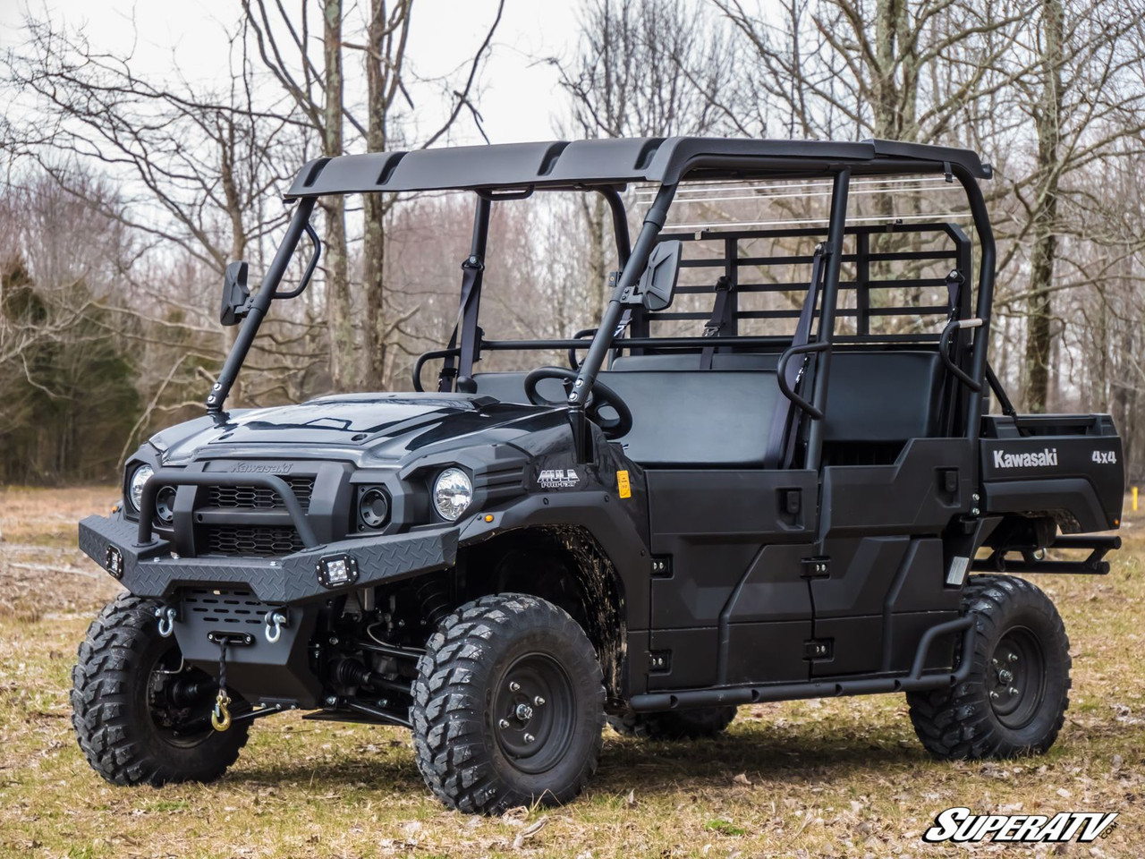 Front three-quarter view of a black Kawasaki Mule Pro with the SuperATV winch ready front bumper in a field