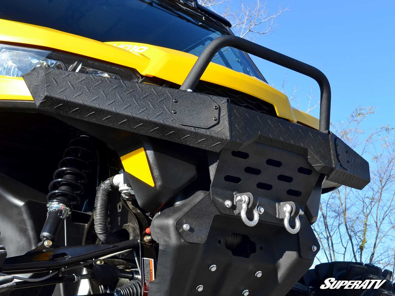 Side close-up of the SuperATV diamond plate front bumper hoop and winch plate on the Can-Am Defender