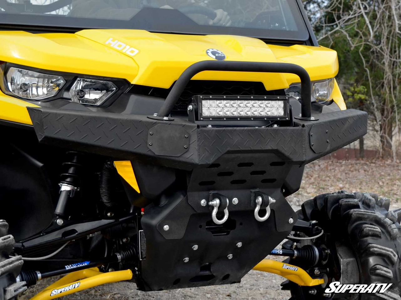 SuperATV diamond plate front bumper on the Can-Am Defender fitted with an LED light bar on the top hoop