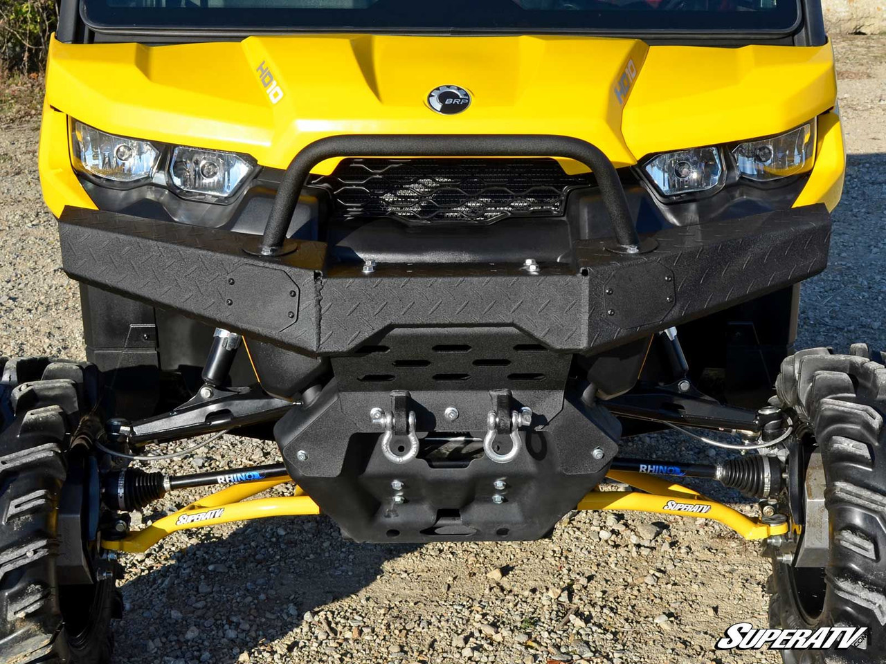 Straight-on front view of the SuperATV diamond plate bumper with shackle mounts on a yellow Can-Am Defender