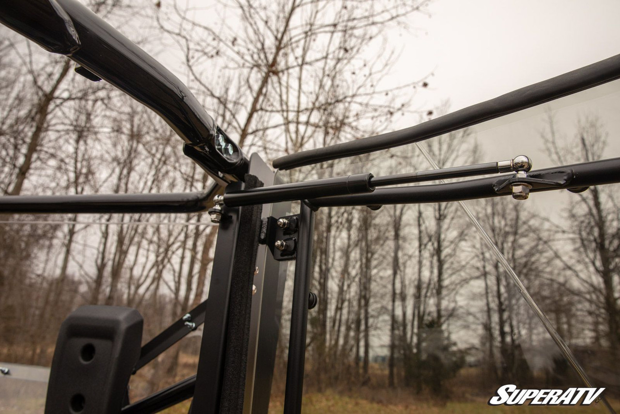 Inside view of the SuperATV Honda Pioneer 1000 cab door tube frame and clear panel seen from the seat