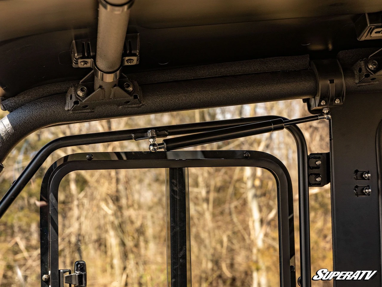 Close-up under the roof of the SuperATV door top frame and roof clamp brackets inside the Yamaha Viking