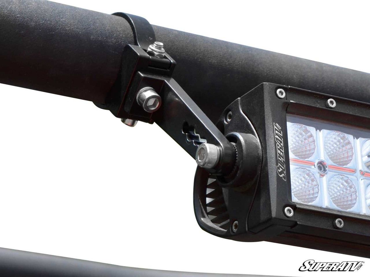 SuperATV aluminum tube clamp mounted on a roll cage bar holding an LED light bar, close-up view