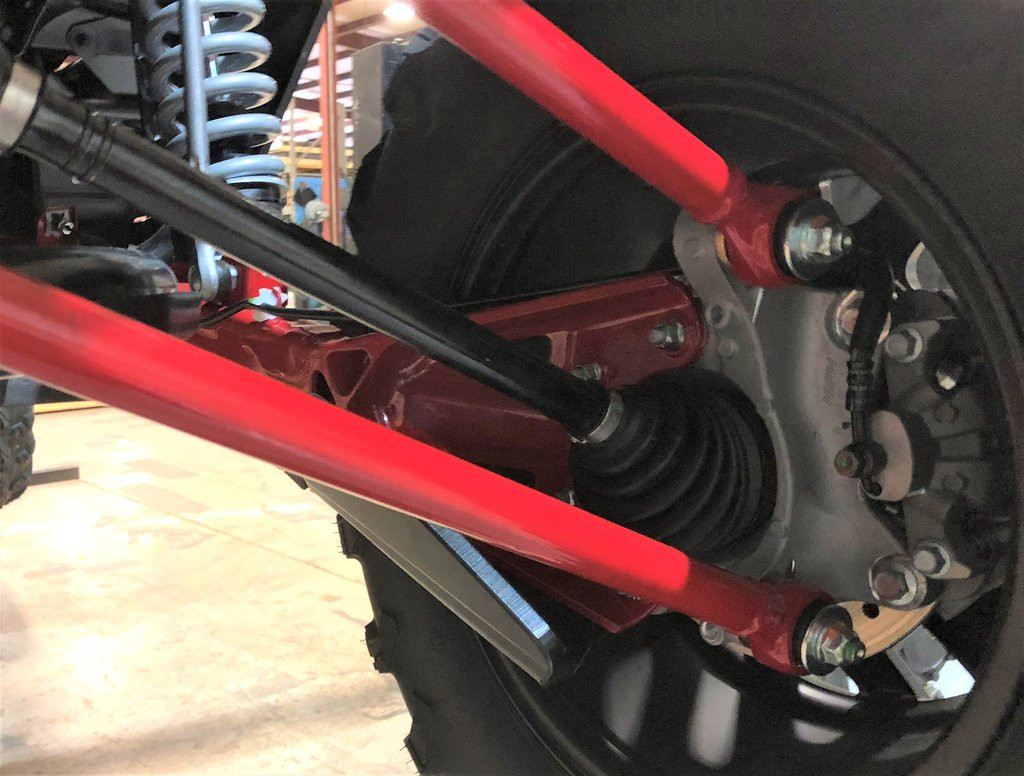 Underside close-up of the Trail Armor trailing arm guard near the hub and CV boot on a Honda Talon 1000 X