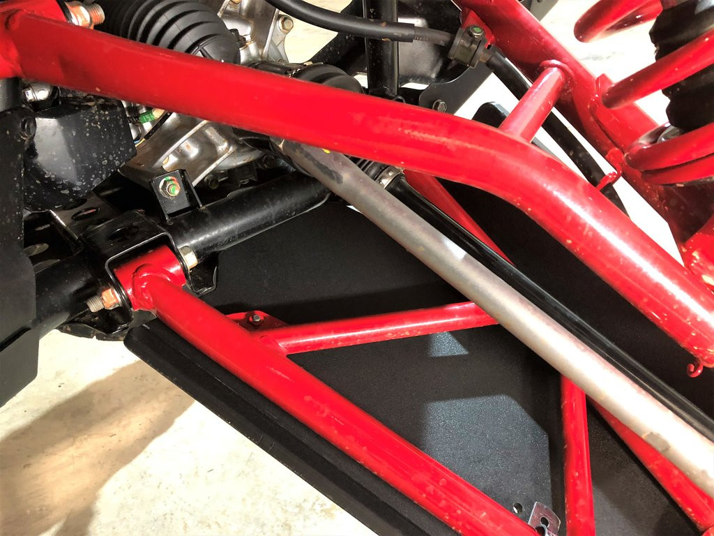 Trail Armor front arm guard beneath the A-arm and tie rod of a Honda Talon 1000R, close view from the front