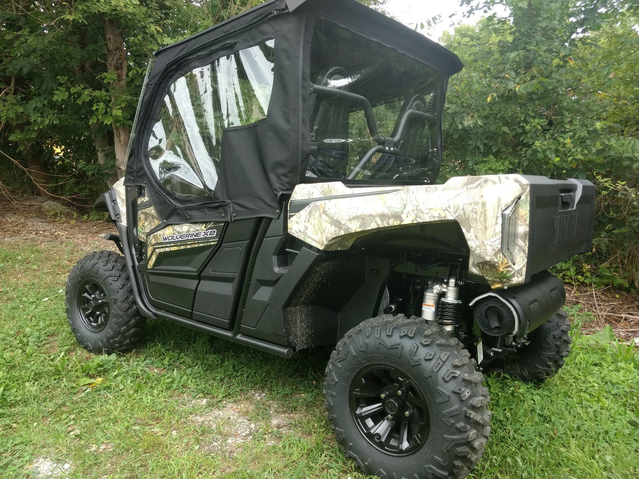 Rear three-quarter view of the Yamaha Wolverine X2 showing the Side X Side enclosure doors and rear window from the bed side