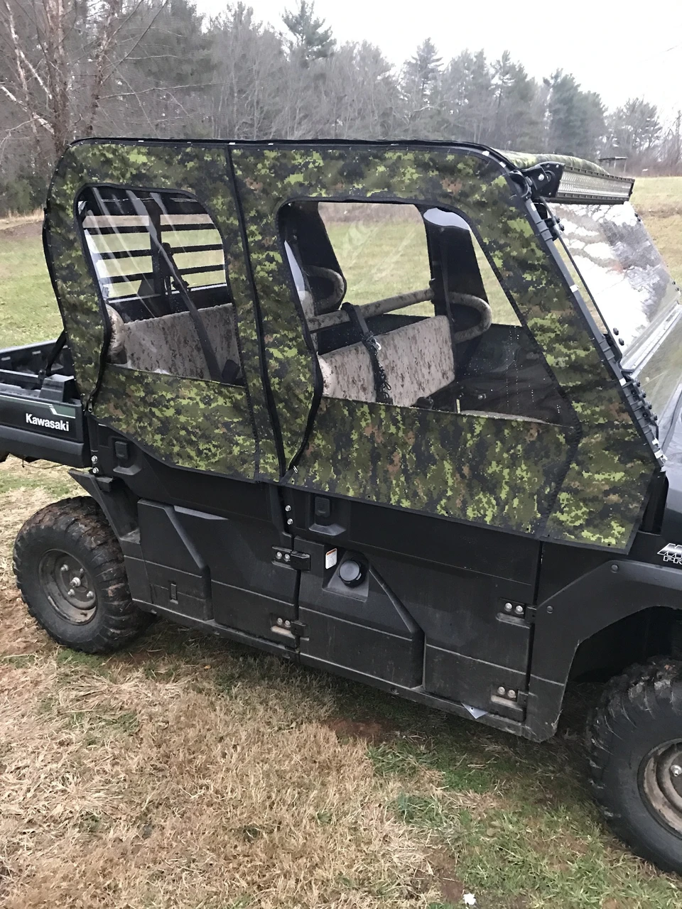 Greene Mountain camo soft doors on a Kawasaki Mule ProFXT, front three-quarter view of the crew cab