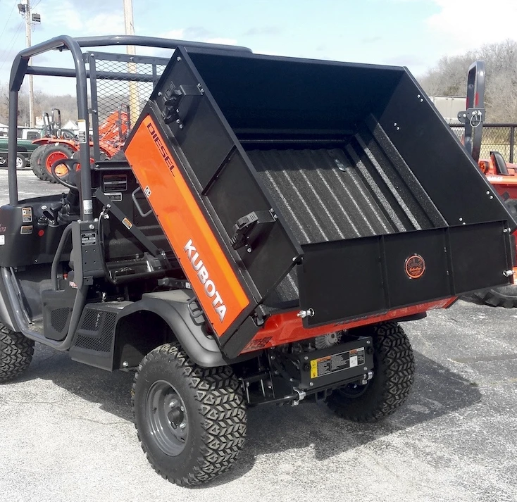 Wiedmann Bros black bed wall extender on a Kubota RTV X-Series with the dump bed raised, rear three-quarter view