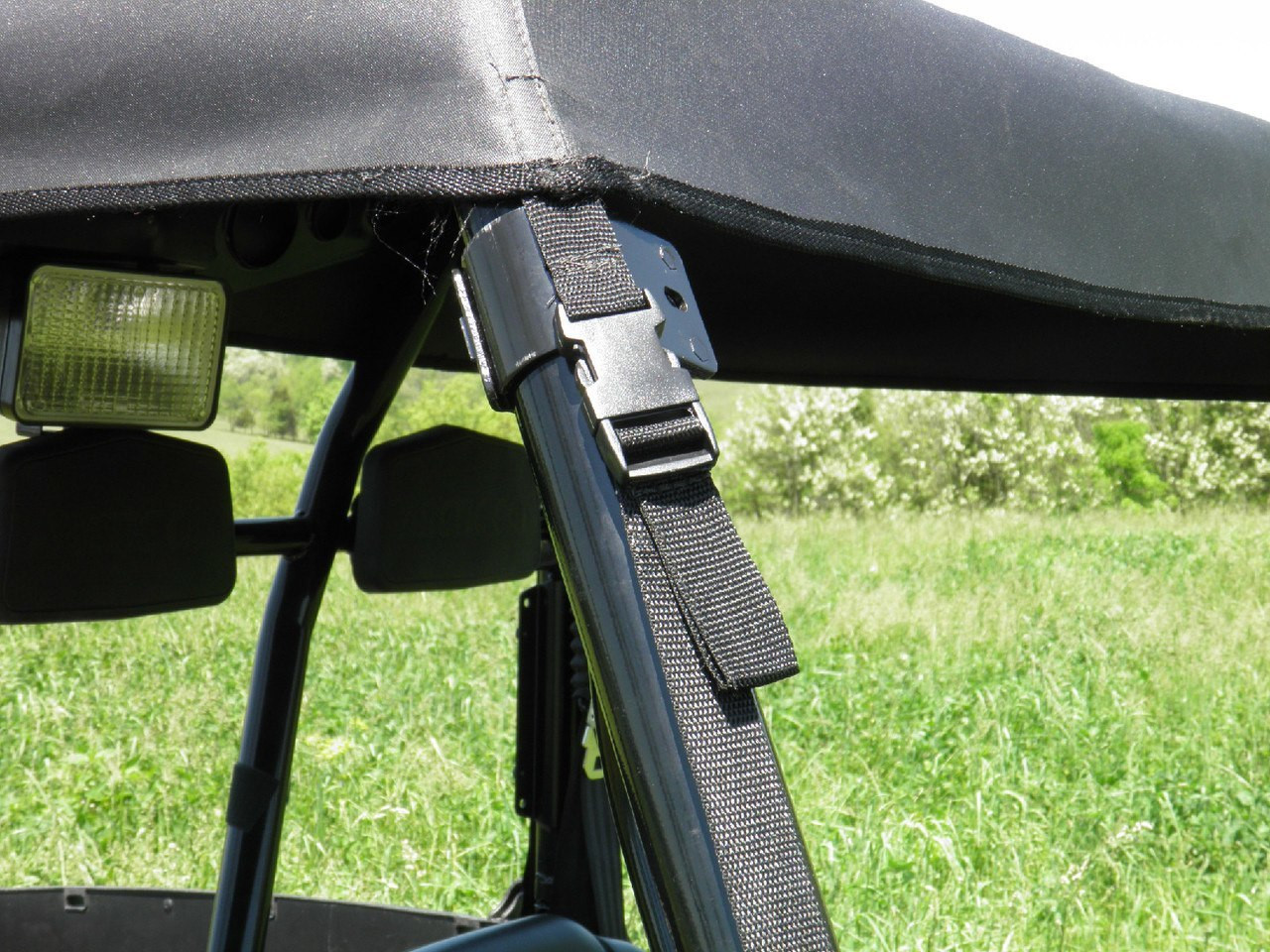 Close-up of the 3 Star soft top strap and buckle wrapped around the Arctic Cat Prowler 700 cage tube