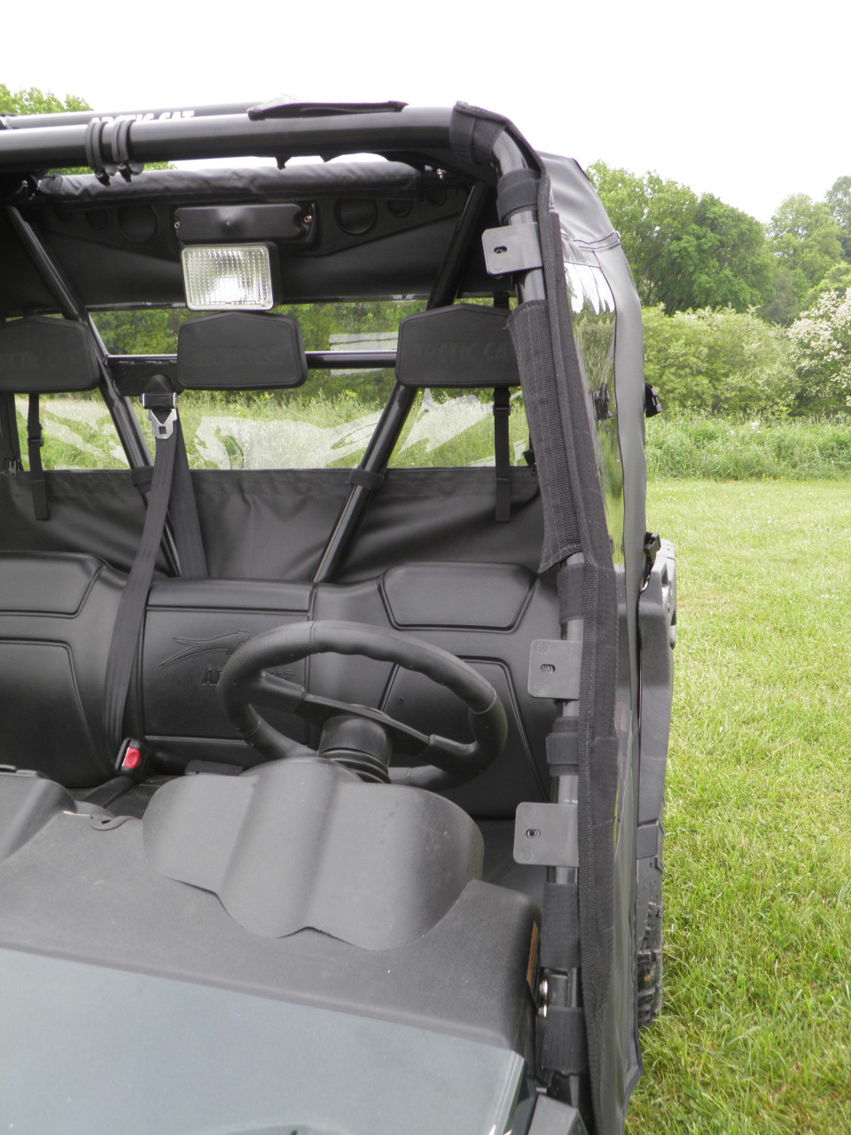Open door view into the Arctic Cat Prowler 700 cab showing the 3 Star soft door edge, seat and steering wheel
