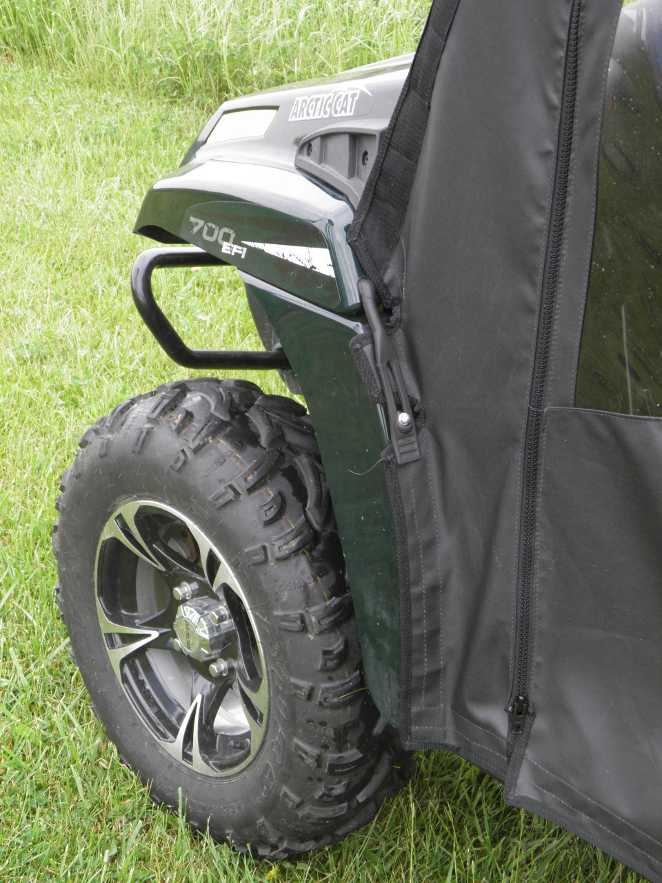 Close-up of the 3 Star soft door front zipper edge beside the front fender and tire of the Arctic Cat Prowler 700