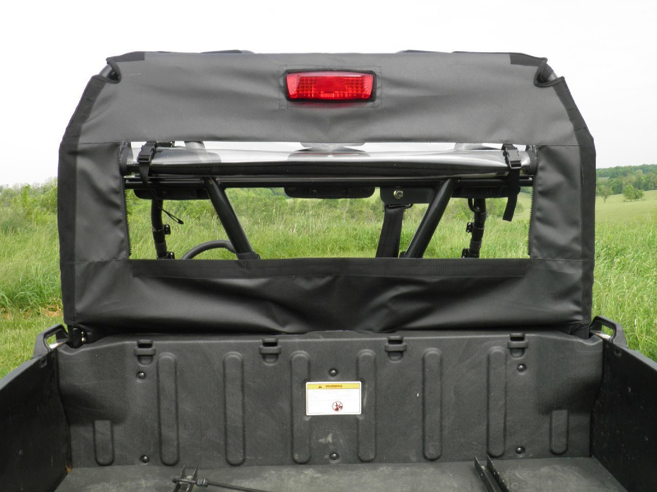 3 Star soft back panel on an Arctic Cat Prowler 700 with the rear window rolled open, view from the bed