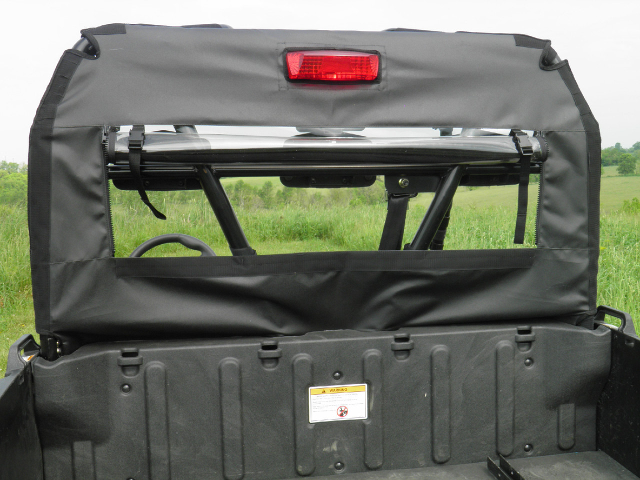 Close-up of the 3 Star rear window panel with clear vinyl above the cargo bed of an Arctic Cat Prowler 700