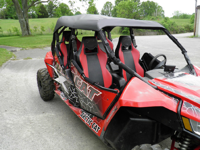 Side close-up of the 3 Star soft top over the seats of a red Arctic Cat Wildcat 4