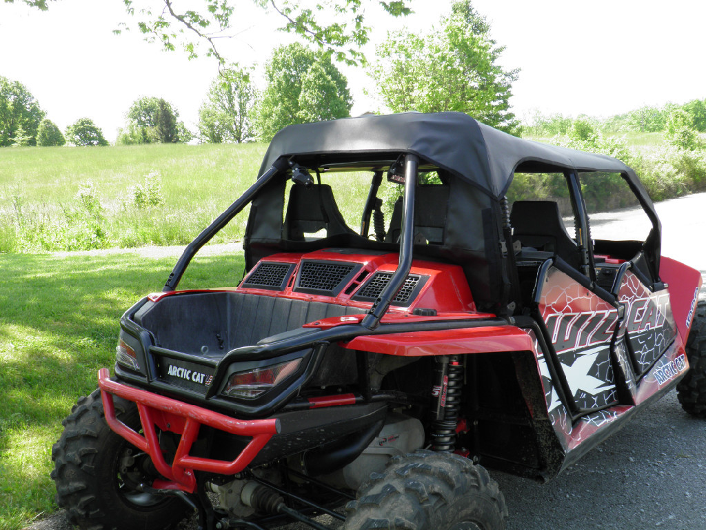 3 Star full cab enclosure with hard windshield on a red Arctic Cat Wildcat 4, front three-quarter view