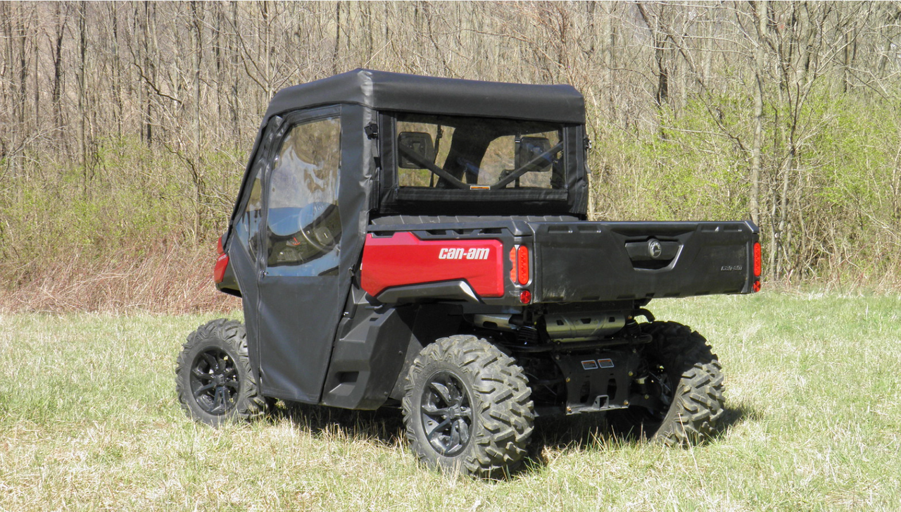 Passenger side rear view of a red Can-Am Defender fitted with the 3 Star vinyl windshield cab enclosure
