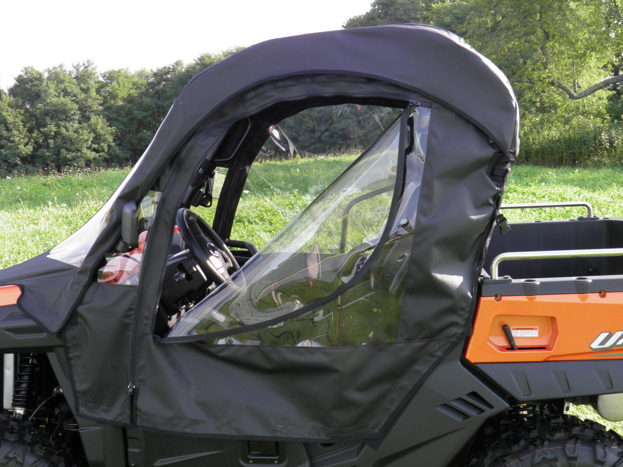 3 Star soft door zipped shut with clear window on a CF Moto UForce, seen from the rear three-quarter