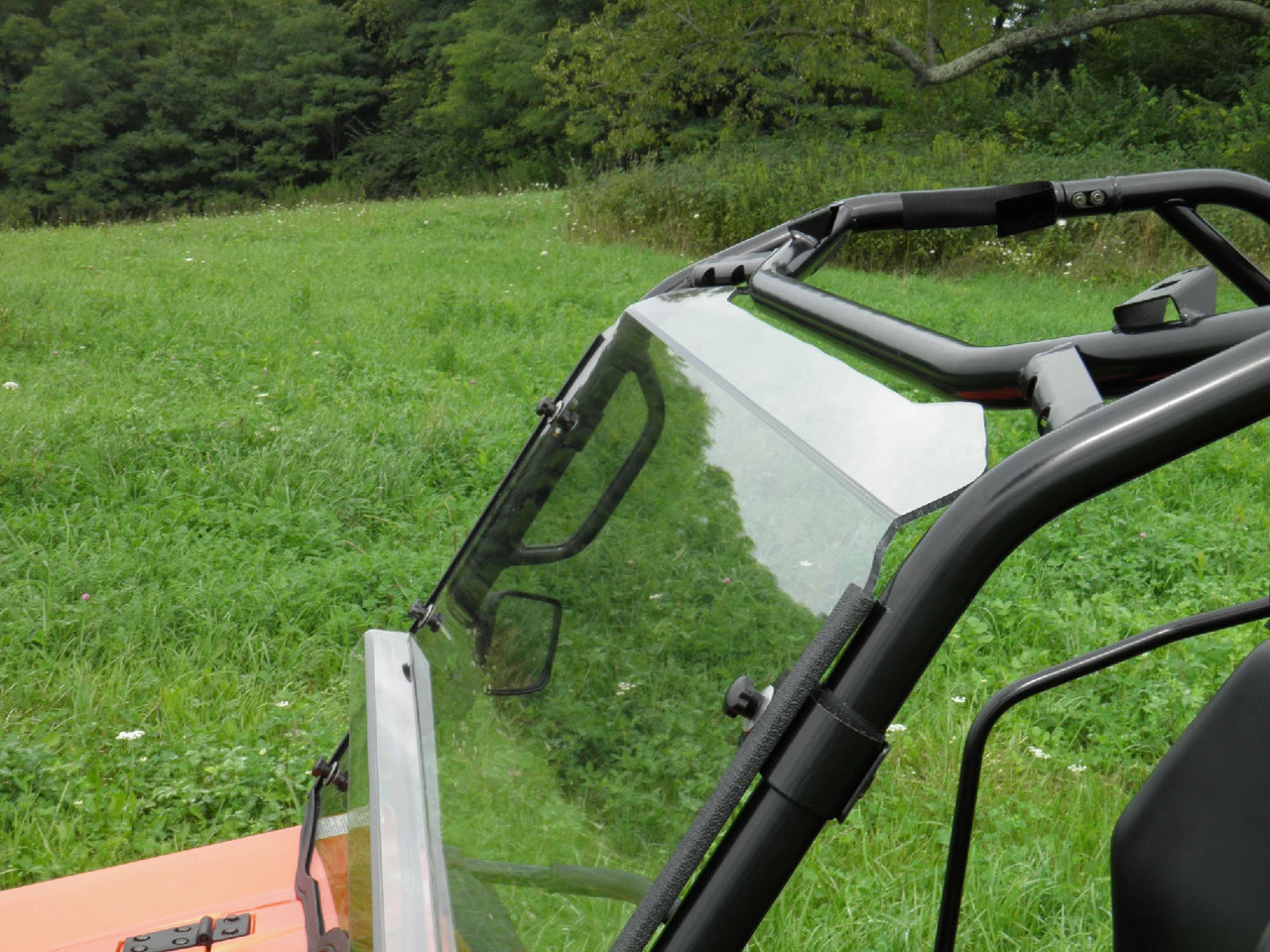 Side view of the 3 Star two-piece windshield edge and mirror bracket on a CF Moto UForce