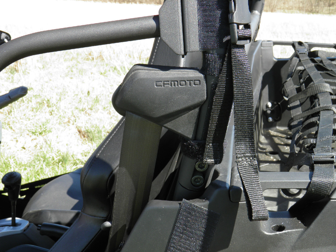 Close-up of the 3 Star soft top strap wrapped around the roll cage of a CF Moto ZForce