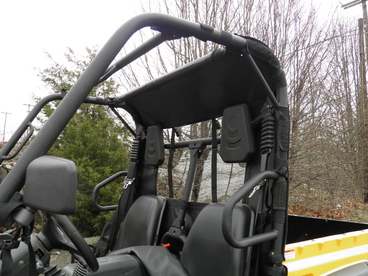 Driver side view through the cage of the 3 Star rear window panel behind the seats of a Cub Cadet Challenger