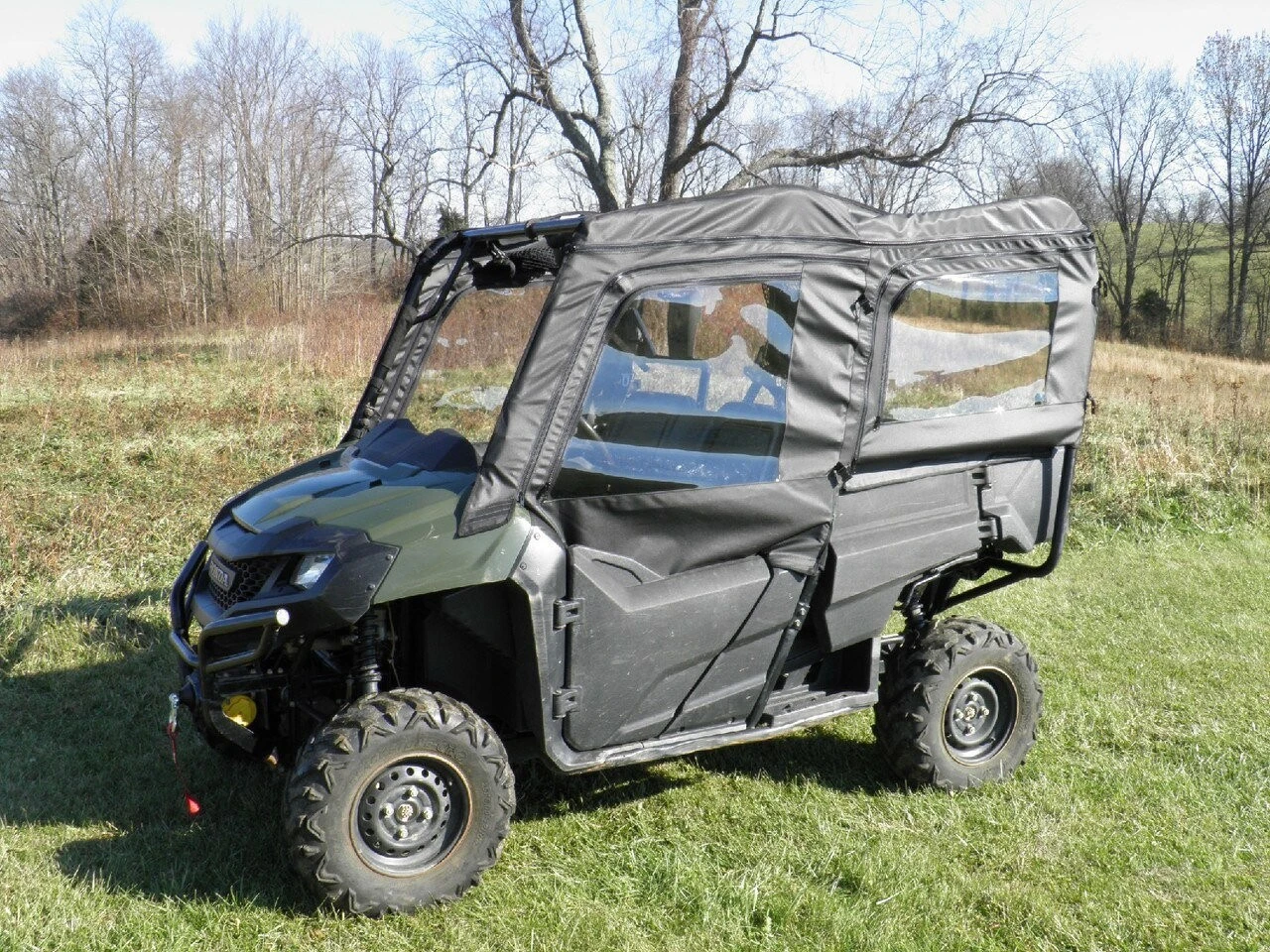 3 Star soft doors on a green Honda Pioneer 700-4, black doors with clear windows, front 3/4 view on grass