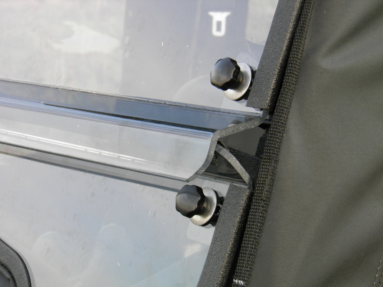 Close-up of the 3 Star windshield split seam and rubber clamp knobs on the Pioneer 700-4